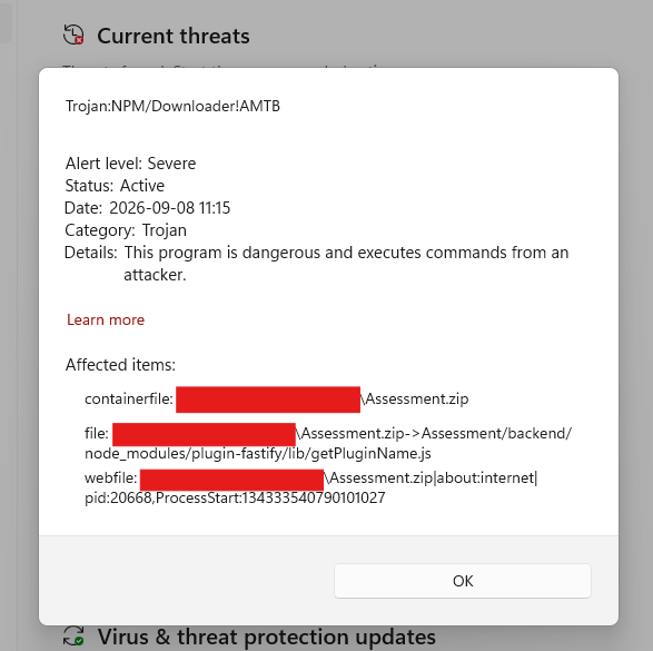 A screenshot of Windows Defender, showing a ZIP file was blocked because it contained a trojan